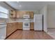 Bright eat-in kitchen featuring wood cabinets, white appliances, and a well-lit space at 6010 Rocky River Dr, Indianapolis, IN 46221
