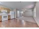 Open floor plan showcasing a bright living room with carpet and an eat-in kitchen area with appliances at 6010 Rocky River Dr, Indianapolis, IN 46221