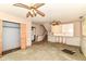 Spacious basement with two ceiling fans, storage cabinets, and access to a staircase at 6238 E 43Rd St, Indianapolis, IN 46226