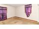 Bright bedroom featuring two windows with purple curtains, neutral colored walls, and carpet at 6238 E 43Rd St, Indianapolis, IN 46226