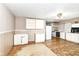 A kitchen needing repair with white cabinets and a linoleum floor at 6238 E 43Rd St, Indianapolis, IN 46226