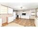 A kitchen needing repair with white cabinets and a linoleum floor at 6238 E 43Rd St, Indianapolis, IN 46226