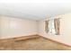 Spacious living room featuring large window with neutral colored walls and carpet at 6238 E 43Rd St, Indianapolis, IN 46226