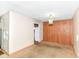 Vacant living room with carpet and wood paneling at 6238 E 43Rd St, Indianapolis, IN 46226