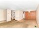 Vacant living room leading to stairs with carpet and wood paneling at 6238 E 43Rd St, Indianapolis, IN 46226