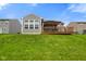 A backyard view shows a deck and gazebo, green grass, and houses in the distance at 6415 Calabash Pl, Indianapolis, IN 46217