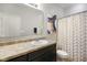 Clean bathroom with decorative shower curtain, and a vanity with a large mirror at 6415 Calabash Pl, Indianapolis, IN 46217