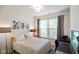 Cozy bedroom with a window, artwork, and a desk area perfect for a home office at 6415 Calabash Pl, Indianapolis, IN 46217