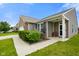 Inviting home entrance with brick accents, a covered porch, and manicured greenery enhancing curb appeal at 6415 Calabash Pl, Indianapolis, IN 46217