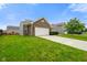 Beautiful brick home with a two-car garage, complemented by a lush green lawn and mature trees at 6415 Calabash Pl, Indianapolis, IN 46217