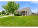 Well-maintained home with a tidy lawn and front garden, complemented by mature trees and a cozy entrance at 6415 Calabash Pl, Indianapolis, IN 46217