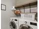 Well-equipped laundry room with front-load washer and dryer, shelving, and ample storage space at 6415 Calabash Pl, Indianapolis, IN 46217