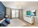 Bright main bedroom features a modern ceiling light, a television, and large windows at 6415 Calabash Pl, Indianapolis, IN 46217