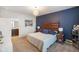 Comfortable main bedroom features a dark accent wall and a door leading to the ensuite bath at 6415 Calabash Pl, Indianapolis, IN 46217