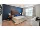 Charming main bedroom features a textured accent wall, a modern chandelier, and a bright window at 6415 Calabash Pl, Indianapolis, IN 46217