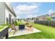 Inviting back patio with comfortable seating and a cozy fire pit, perfect for outdoor entertaining and relaxation at 6556 Sulgrove Pl, Indianapolis, IN 46221