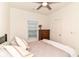 Well lit bedroom featuring a ceiling fan and a dresser by the window at 6556 Sulgrove Pl, Indianapolis, IN 46221