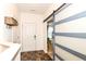 Bright entryway with stylish sliding barn door, modern light fixtures, and functional storage solutions at 6556 Sulgrove Pl, Indianapolis, IN 46221