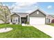 Charming single-Gathering home with green lawn, concrete driveway, and inviting front entrance at 6556 Sulgrove Pl, Indianapolis, IN 46221