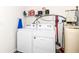This laundry room features a washer and dryer and storage shelves at 6556 Sulgrove Pl, Indianapolis, IN 46221