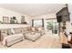 Open living space with sectional sofa, entertainment center and sliding glass doors to outdoor patio and fenced yard at 6556 Sulgrove Pl, Indianapolis, IN 46221