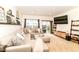 Comfortable living room with a sectional sofa, display shelves, and sliding doors leading to an outdoor space at 6556 Sulgrove Pl, Indianapolis, IN 46221