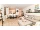 Inviting open-concept living space with a sectional sofa, dining table, and seamless flow to a charming dining area at 6556 Sulgrove Pl, Indianapolis, IN 46221