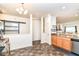 Open living space with kitchen, barn door, and view of the living room at 6556 Sulgrove Pl, Indianapolis, IN 46221
