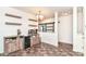 Open living space featuring a bar and kitchen view through sliding barn door at 6556 Sulgrove Pl, Indianapolis, IN 46221