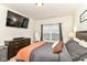 Well-lit bedroom with TV, dresser, comfortable bed, and stylish window treatments, creating a relaxing retreat at 6556 Sulgrove Pl, Indianapolis, IN 46221