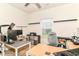 Well-lit home office featuring multiple workstations and ceiling fan at 6556 Sulgrove Pl, Indianapolis, IN 46221