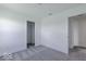A bright bedroom features neutral carpet, white walls, trim, and doors with convenient access to a closet and doorway at 6771 W Buck Stone Dr, McCordsville, IN 46055