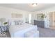 Comfortable bedroom with bright natural light, stylish lamps, and a decorative dresser at 6771 W Buck Stone Dr, McCordsville, IN 46055
