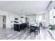 Spacious kitchen features a central island, stainless steel appliances, and modern black and white color scheme at 6771 W Buck Stone Dr, McCordsville, IN 46055