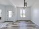 Stylish and modern living room with wood floors, neutral walls, and contemporary lighting at 6771 W Buck Stone Dr, McCordsville, IN 46055