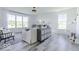 Bright living room with large windows, white walls, modern furniture, and stylish decor at 6771 W Buck Stone Dr, McCordsville, IN 46055
