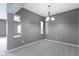 Neutral dining room showcasing gray walls, a chandelier and easy access to other rooms for seamless flow at 7128 Willow Pond Dr, Noblesville, IN 46062