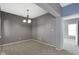 Neutral dining room features gray walls, chandelier, and an adjacent room that offers versatile space at 7128 Willow Pond Dr, Noblesville, IN 46062