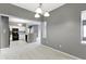 Spacious dining room displays gray walls and views into the kitchen, creating an inviting open-concept layout at 7128 Willow Pond Dr, Noblesville, IN 46062