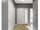 Foyer with tile flooring, coat closet, and a white front door with sidelight window at 7128 Willow Pond Dr, Noblesville, IN 46062