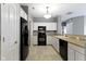 Traditional kitchen features white cabinetry, black appliances and an open layout for easy entertaining at 7128 Willow Pond Dr, Noblesville, IN 46062