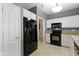 Traditional kitchen offers white cabinetry, black appliances and access to the laundry room at 7128 Willow Pond Dr, Noblesville, IN 46062