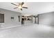 Bright living room with gray walls, neutral carpets, and a view into the kitchen with a breakfast bar at 7128 Willow Pond Dr, Noblesville, IN 46062