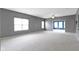 Expansive living room featuring neutral carpeting, gray walls, ceiling fan and plenty of natural light at 7128 Willow Pond Dr, Noblesville, IN 46062