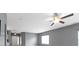 Open living room features gray walls, neutral carpets, and access to the kitchen with modern appliances at 7128 Willow Pond Dr, Noblesville, IN 46062
