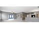 Open-concept living room showcasing gray walls, neutral carpets and an eat-in kitchen area with bar seating at 7128 Willow Pond Dr, Noblesville, IN 46062