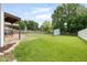 Expansive backyard with a patio, pergola, shed, and a privacy fence at 7541 Southern Lakes Dr, Indianapolis, IN 46237