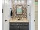Stylish bathroom featuring a decorative mosaic tile backsplash, granite countertop, and modern fixtures at 7541 Southern Lakes Dr, Indianapolis, IN 46237