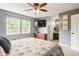 Comfortable bedroom showcasing natural light, a TV, and ensuite bathroom with decorative wall at 7541 Southern Lakes Dr, Indianapolis, IN 46237