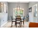 Cozy dining area with views of the backyard and features modern decor and light wood-look flooring at 7541 Southern Lakes Dr, Indianapolis, IN 46237